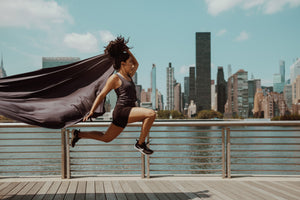 Woman running with New York skyline in the background wearing Joob tietank